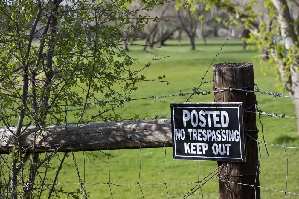 Fence post with trespassing sign