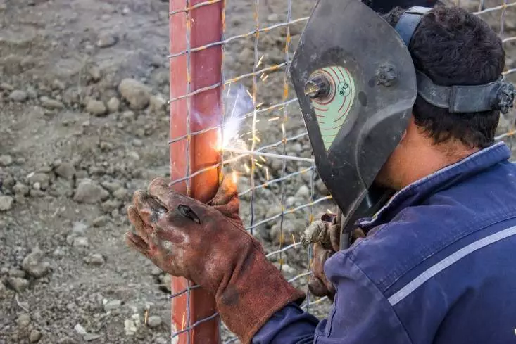 Welding fence panels onto a post