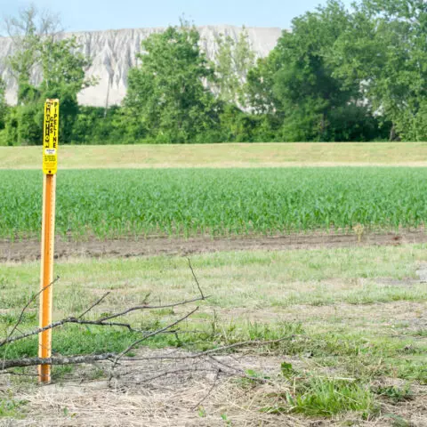 Field with pipeline marker in view
